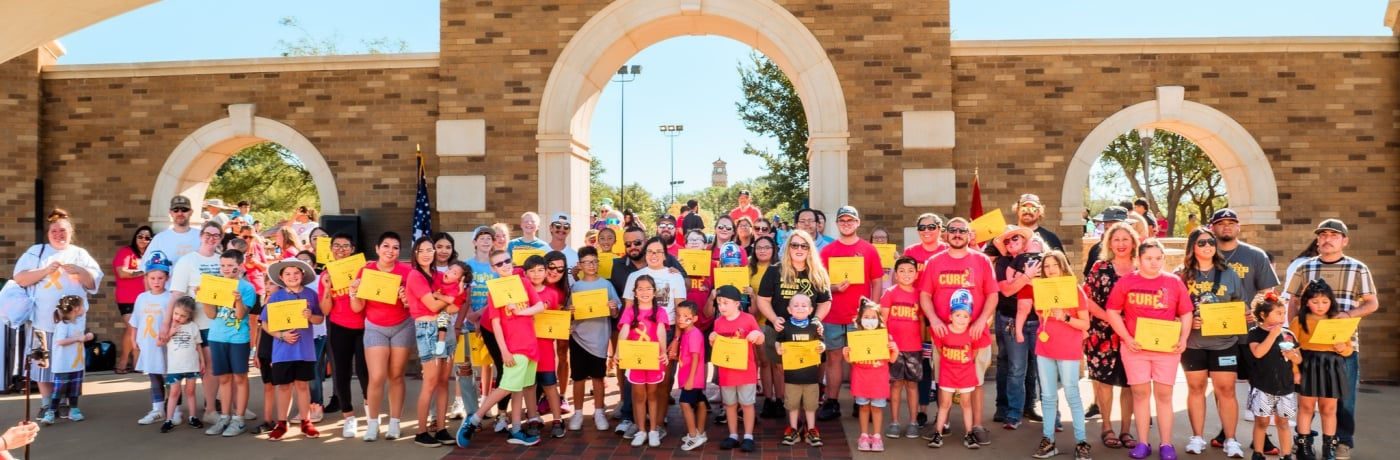 Dozens of families gathered under the brick arches at Urbanovsky Park, each holding a gold certificate from the Lubbock Pediatric Cancer Walk.